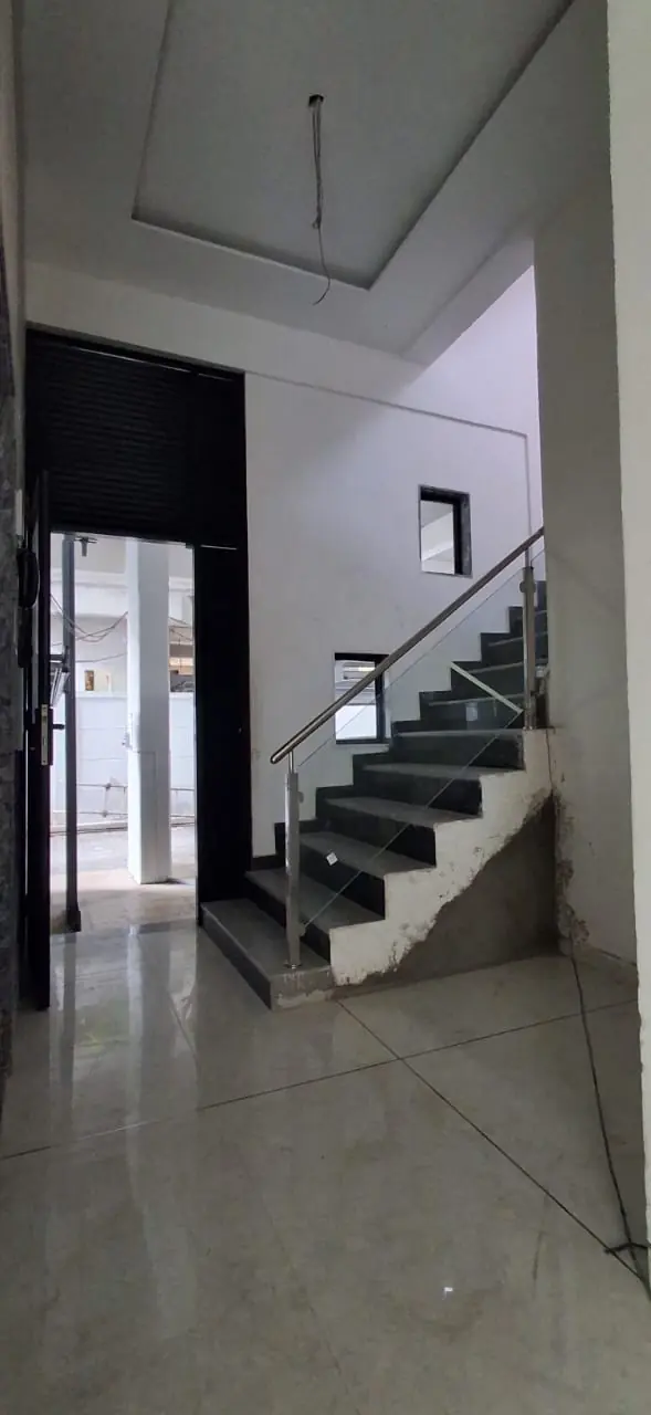 Ground floor lobby with stairs and polished flooring